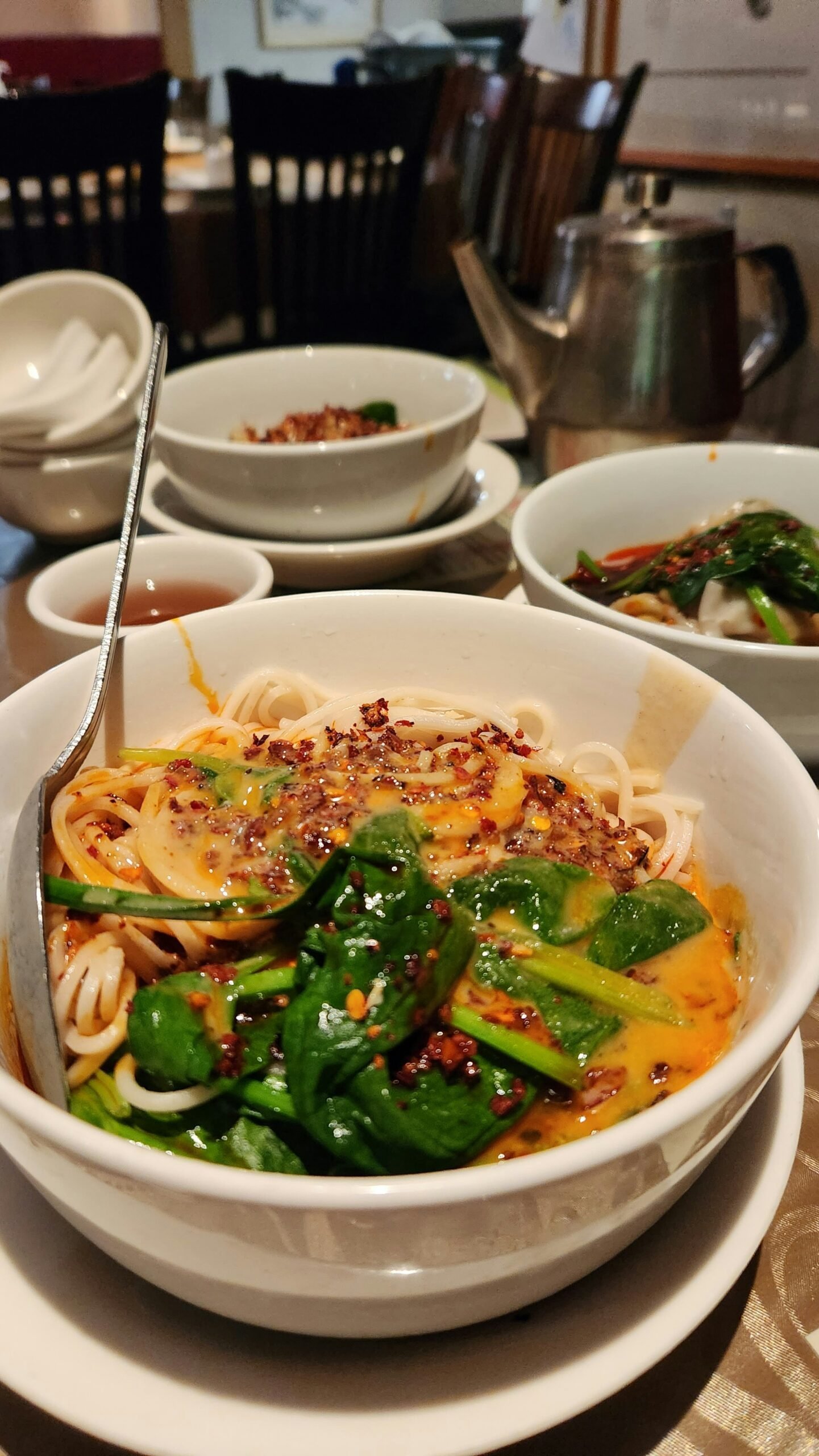 a bowl of noodles and vegetables on a table